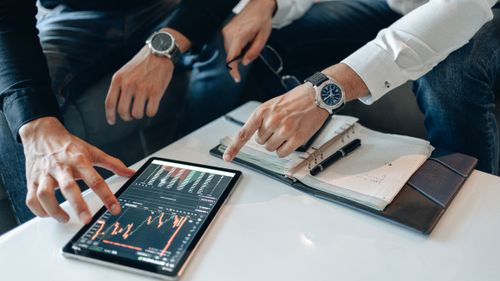 People reviewing financial charts together at a table