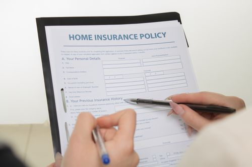 An insurance policy being completed with a pen